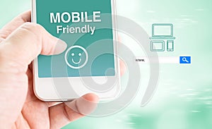 Hand touch mobile phone with mobile friendly word with search bo