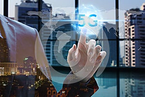 Hand touch network using 5G technology with virtual screen icons on the city background, Technology Internet 5G global network