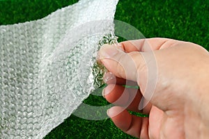 The hand touches bubble wrap. The concept of touch, tactility, feelings