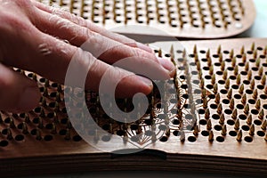 The hand touches the sadhu's board. Yoga Practice with Nails