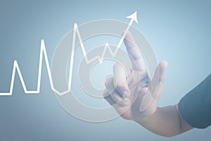 Hand touching graphs of financial indicator and accounting market economy analysis chart