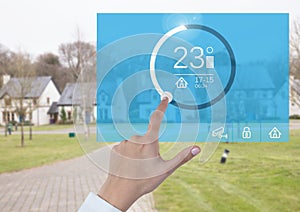 Hand touching a Home automation system temperature App Interface