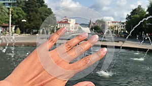 Hand touching landscape Batumi, Adjaria Georgia Singing fountains in Batumi, tactile sensations, inspirational