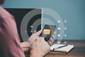 Hand touching on Mobile phone screen with cyber network, Folder, Document,Storage, Server and Cloud computing management concept.