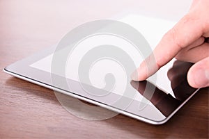 Hand touching screen on modern digital tablet pc