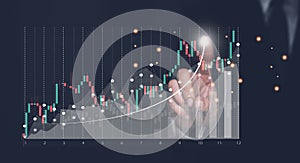 Hand touching screen with virtual increasing technical graph for trader analysis business stock market chart concept