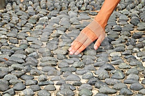 Hand Touching Stone Surface