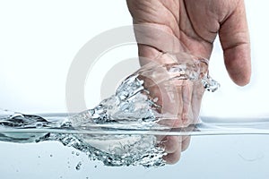 Hand touching the surface of water