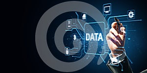Hand touching virtual data interface with digital icons on dark background