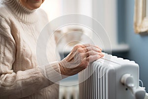A hand touching white radiator of a central heating system, checking the temperature of a heater, warm and cozy home