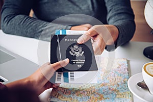 Hand for tourist holding passport to authorities photo