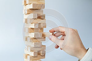 Hand and tower of wooden blocks