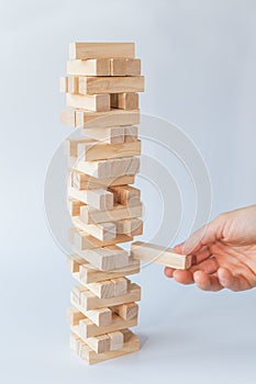 Hand and tower of wooden blocks
