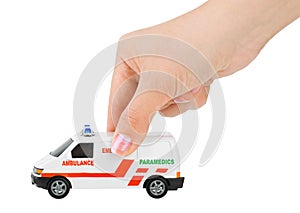 Hand with toy ambulance car