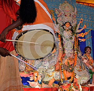 Hand of a traditional Dhaki playing dhaak during Durga Puja festival