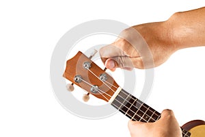 Hand tuning ukulele on white