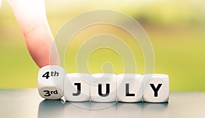 Hand tuns dice and changes the date `3rd of July` to `4th of July`.