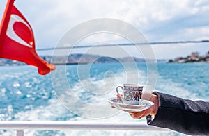hand with turkish coffee cup and flag. Travel concept
