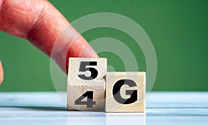 Hand turn wooden block and change technology word 4G to 5G. Network future. High speed of mobile internet