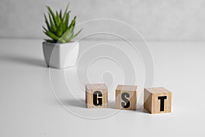 The hand turn wooden block. concept of GST. Word GST conceptual symbol.
