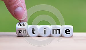 Hand is turning a dice and changes the word `full-time` to `part-time`