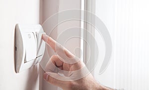 Hand turning off on light switch