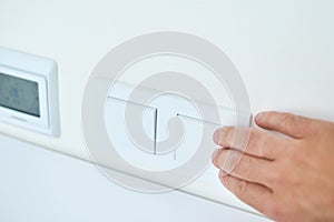 Hand is turning on or off on light switch, closeup