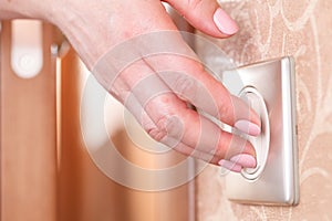 Hand turning wall light switch