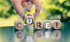 Hand turns a cube and changes the word `care` to `cure`