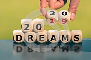 Hand turns cubes and changes the expression `2019 dreams` to `2020 dreams`