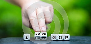 Hand turns dice and changea the expression `I hate GOP` grand old party to `I love GOP`. photo