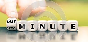 Hand turns a dice and changes the expression `first minute` to `last minute.