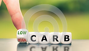 Hand turns a dice and changes the expression from `high carb` to `low carb`.