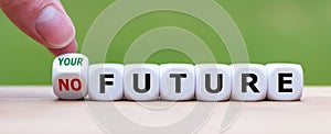 Hand turns a dice and changes the expression `no future` to `your future`.