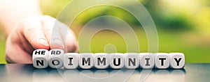 Hand turns dice and changes the expression `no immunity` to `herd immunity`.