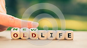 Hand turns dice and changes the expression `old life` to `new life`.