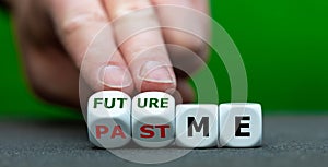 Hand turns dice and changes the expression `past me` to `future me`.
