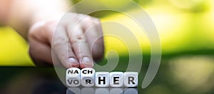 Hand turns dice and changes the German word `vorher` before to `nachher` after.