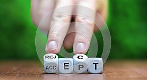 Hand turns dice and changes the word accept to reject.