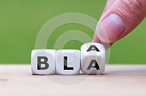 Hand turns a dice and changes the word `bla` to `bla