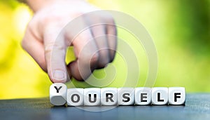 Hand turns dice and changes the word ourself to yourself.