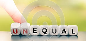 Hand turns dice and changes the word unequal to equal