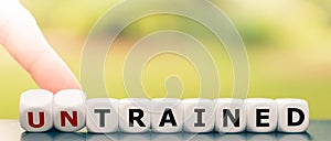 Hand turns dice and changes the word `untrained` to `trained`.