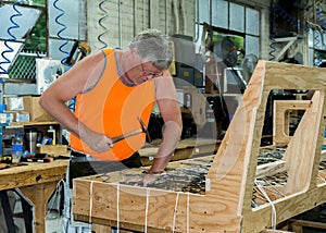 hand tying springs in a sofa frame