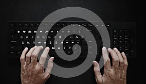 Hand typing on computer keyboard, with application icons on button. Application Programming Interface