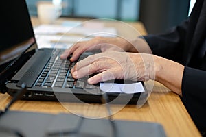 hand typing on computer laptop keyboard working at home office