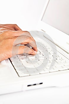 Hand typing keyboard on laptop