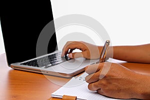 Hand typing a laptop on vintage wooden tables