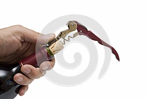A hand uncorking the bottle.