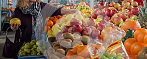 Hand of unrecognizable woman choosing fruit at fresh fruit produce local market